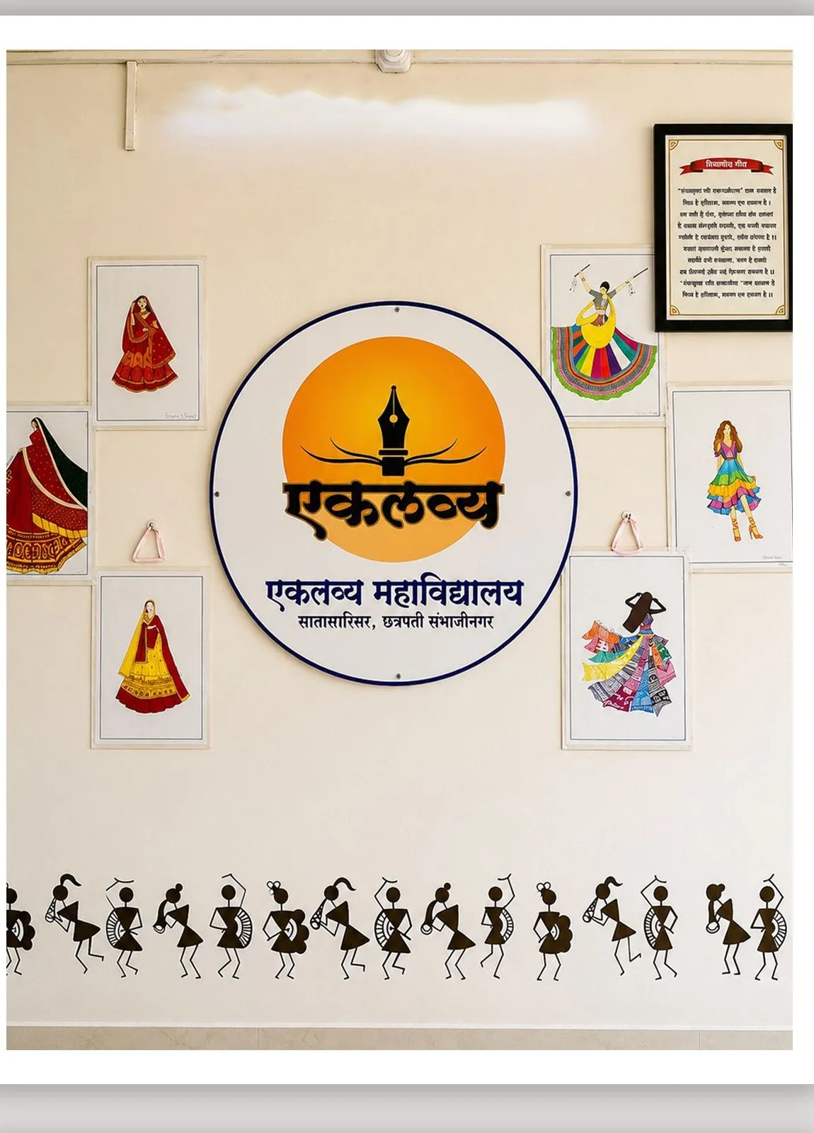 The college crest on a wall surrounded by student fashion illustrations